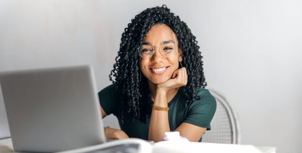 A digital marketing specialist works with a smile on her face